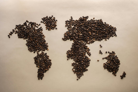 A rough map of the world using coffee beans to create landmasses.