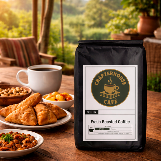 Chapterhouse Cafe coffee bag on a wooden table with food and coffee in the background
